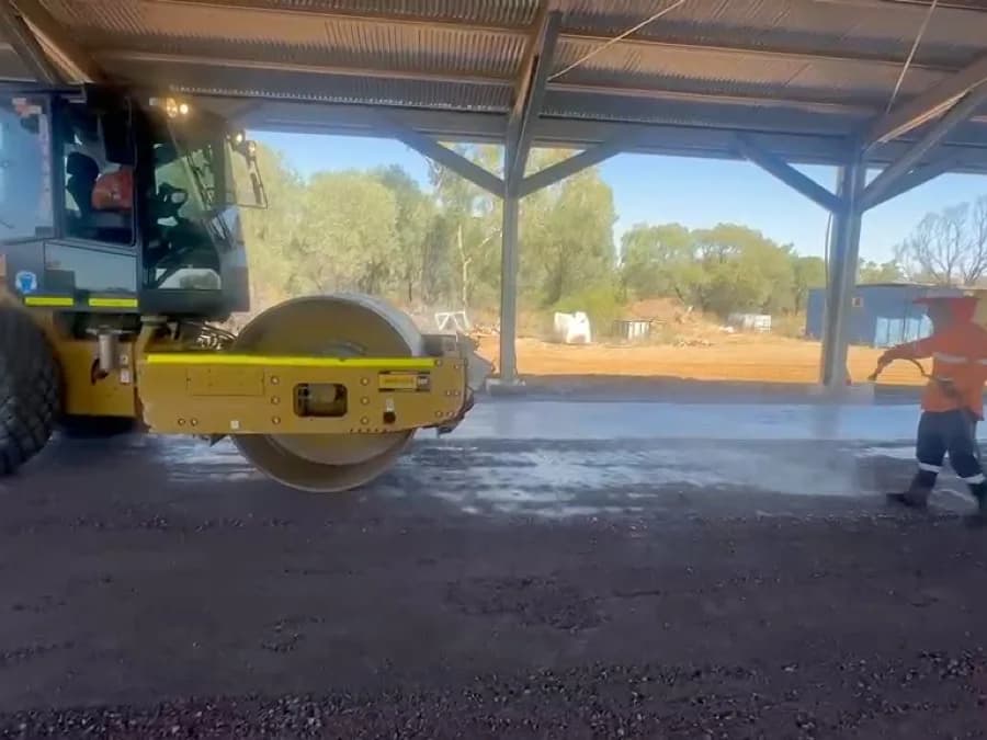A smooth drum roller wet rolling the base to final compaction